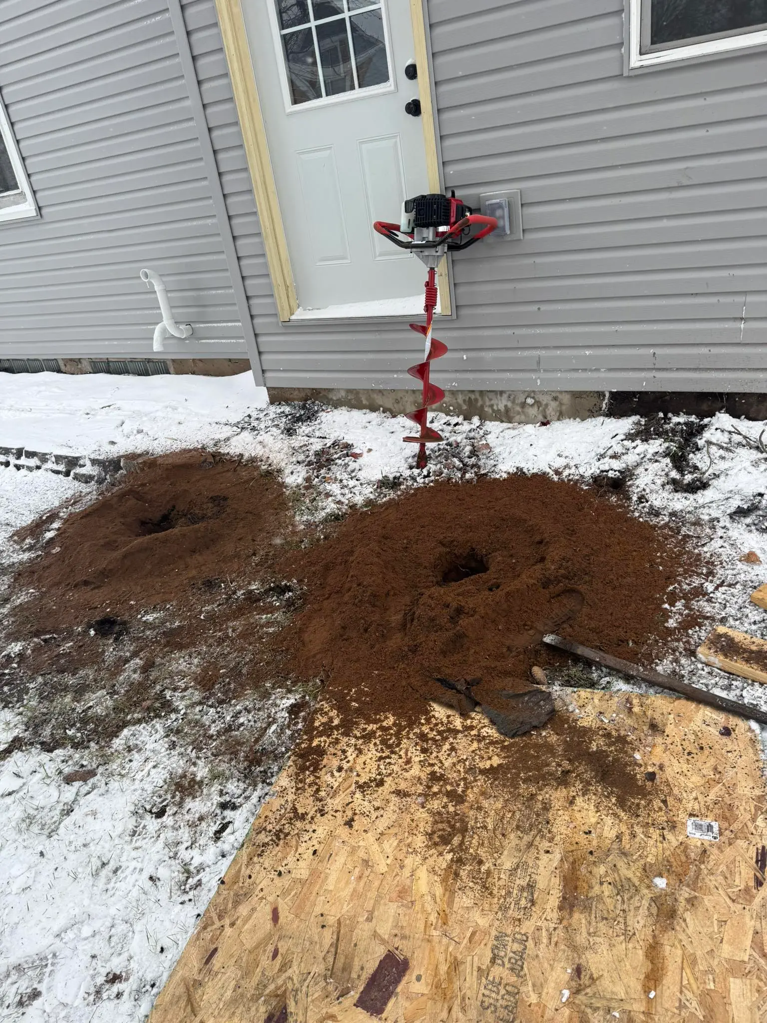 Post hole digging for construction project in the Chippewa Valley by Bergeron Builders